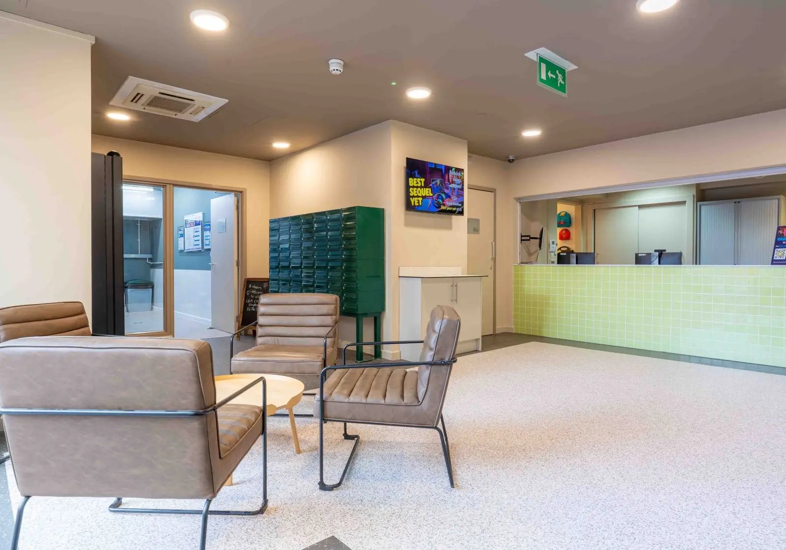 Chairs mailboxes and reception desk common area at iQ The Arcade in London Student Accommodation