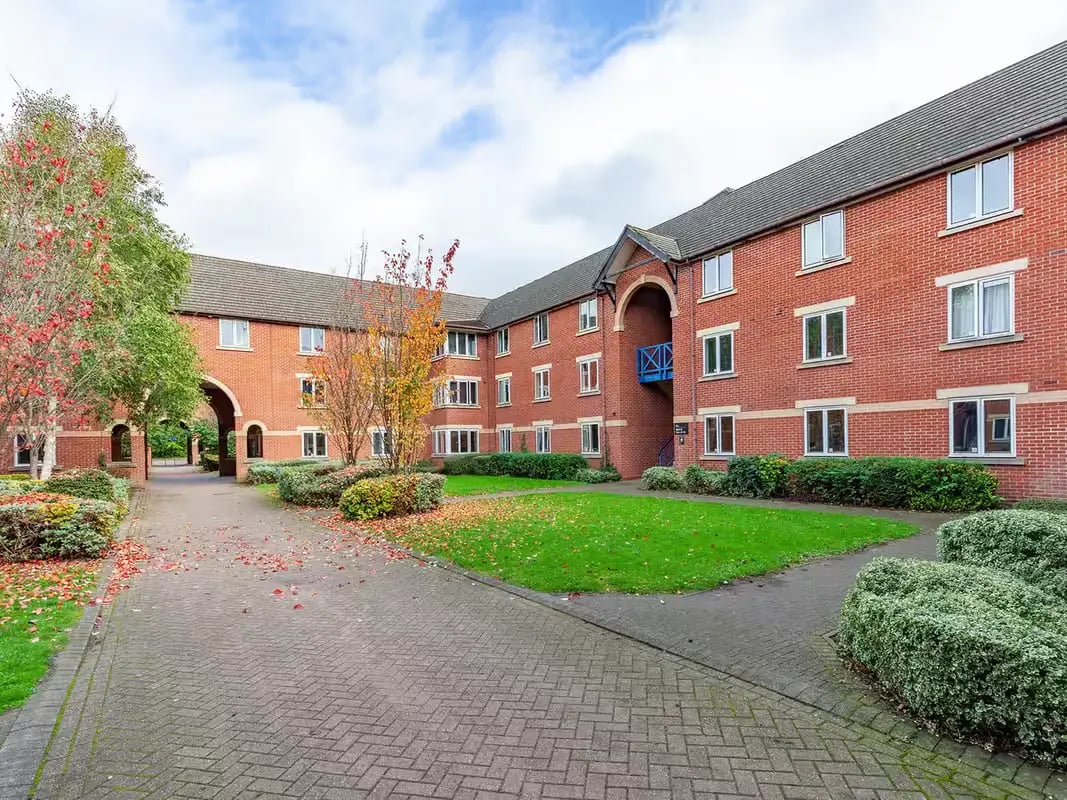 Red brick building with green lawn exterior at Calthorpe Court in Birmingham Student Accommodation