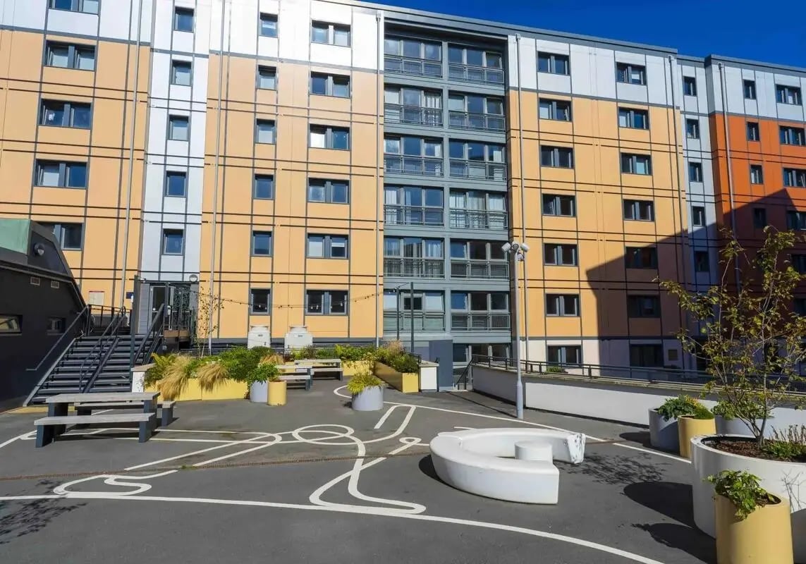 Outdoor seating area with building exterior at iQ Kerria Apartments in Manchester Student Accommodation