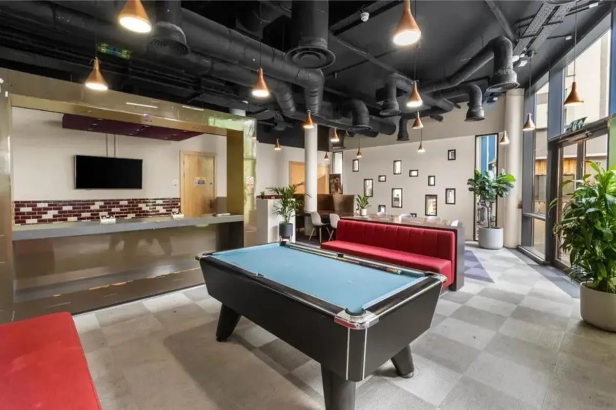 Pool table red booth reception area communal area at Chapter Highbury in London Student Accommodation