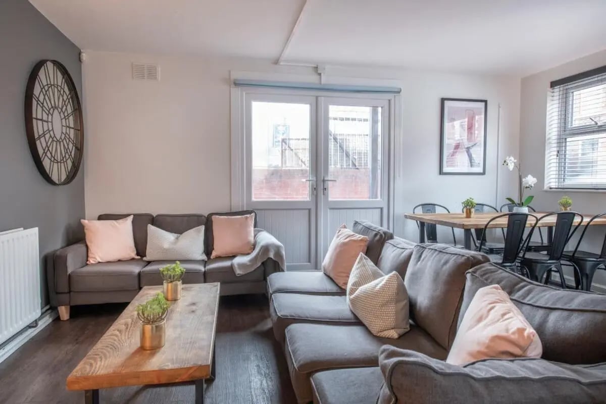 Gray sofas wooden table dining chairs living room at 28 Church Street in Nottingham Student Accommodation