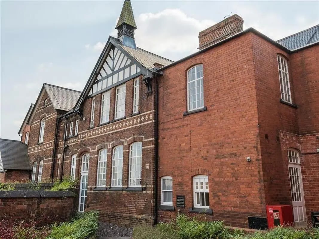 Brick building with many windows and a spire exterior at Abbeygate in Chester Student Accommodation