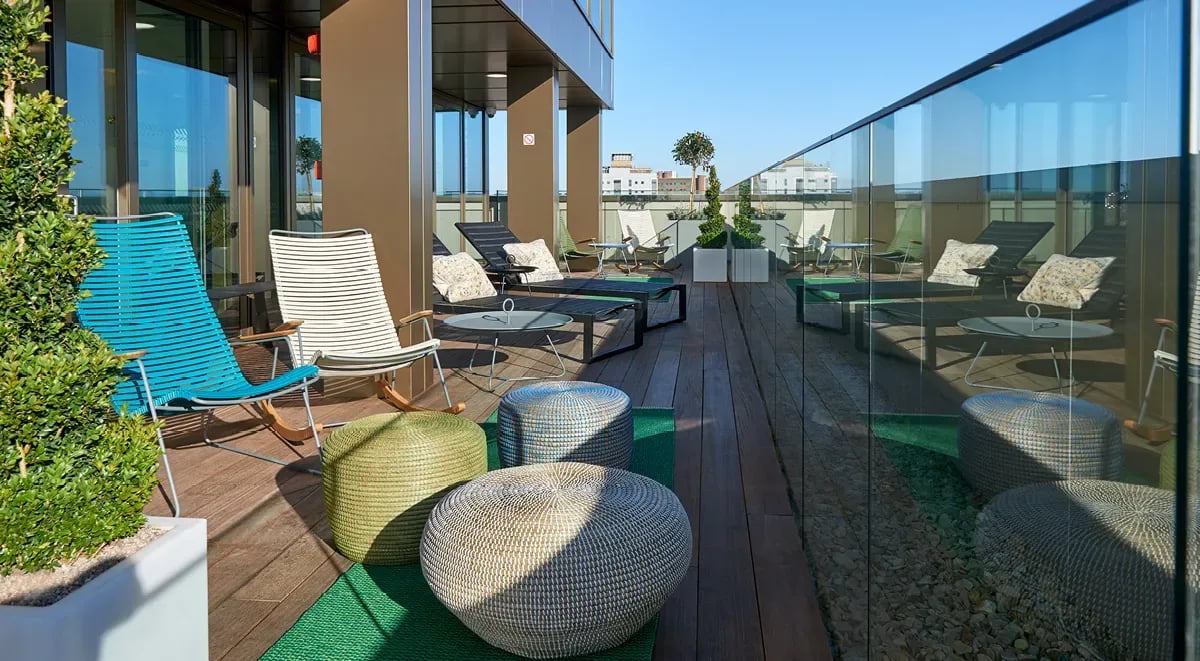 Chairs loungers tables and ottomans on deck terrace at Cumberland Place in Southampton Student Accommodation