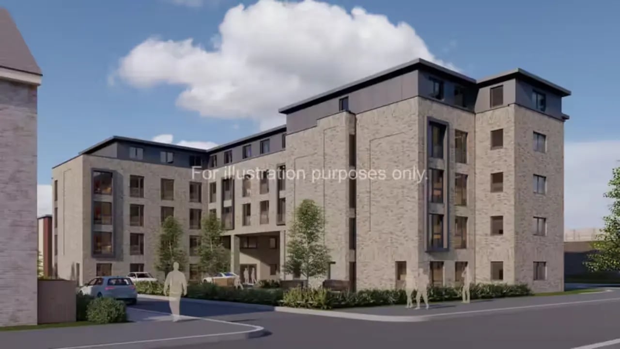 Modern brick building with windows cars people exterior at Scholars View in Cambridge Student Accommodation
