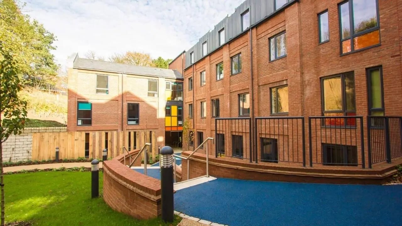 Modern brick student accommodation with blue outdoor area exterior at The Village at The Viaduct in Durham Student Accommodation