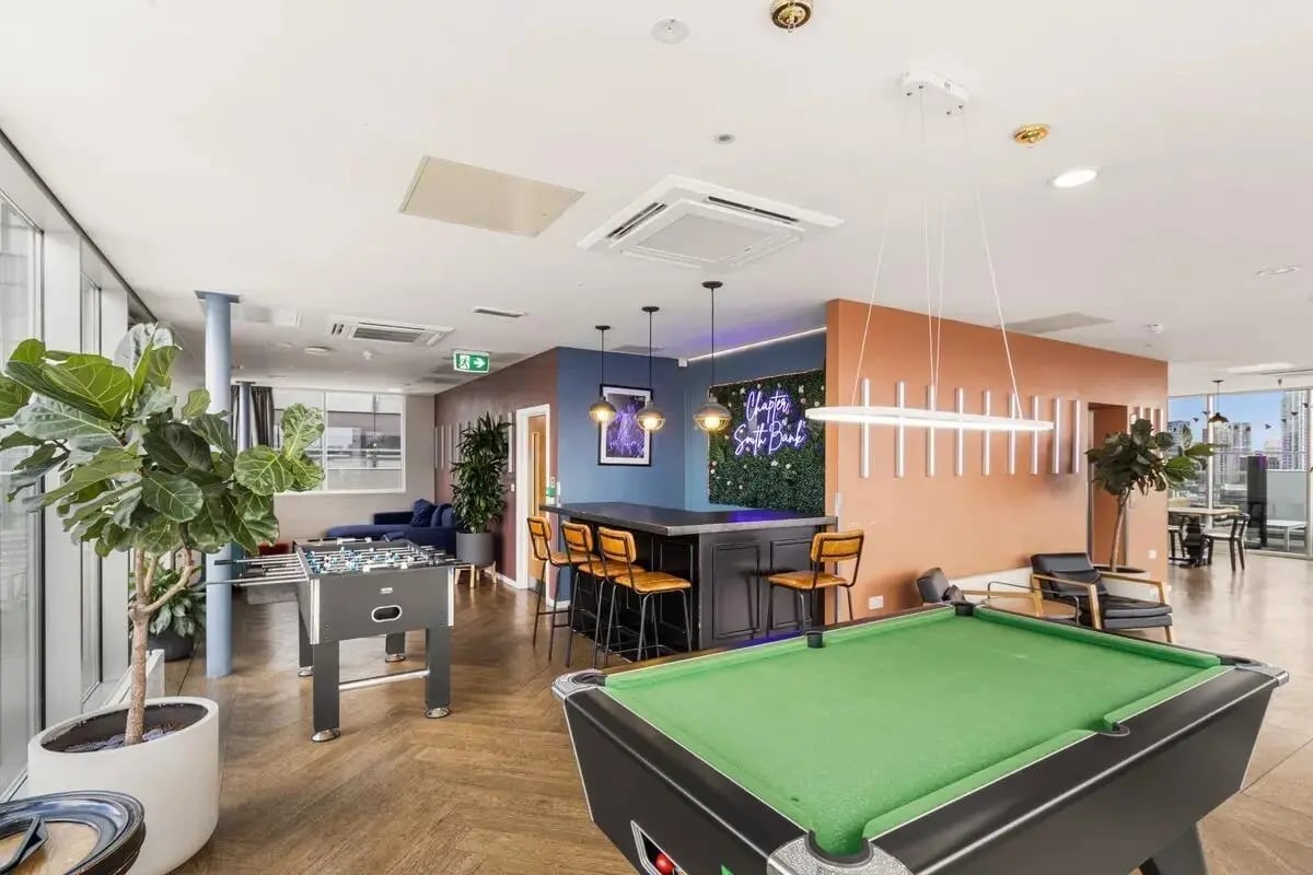 Pool table foosball table bar living room common area at Chapter South Bank in London Student Accommodation