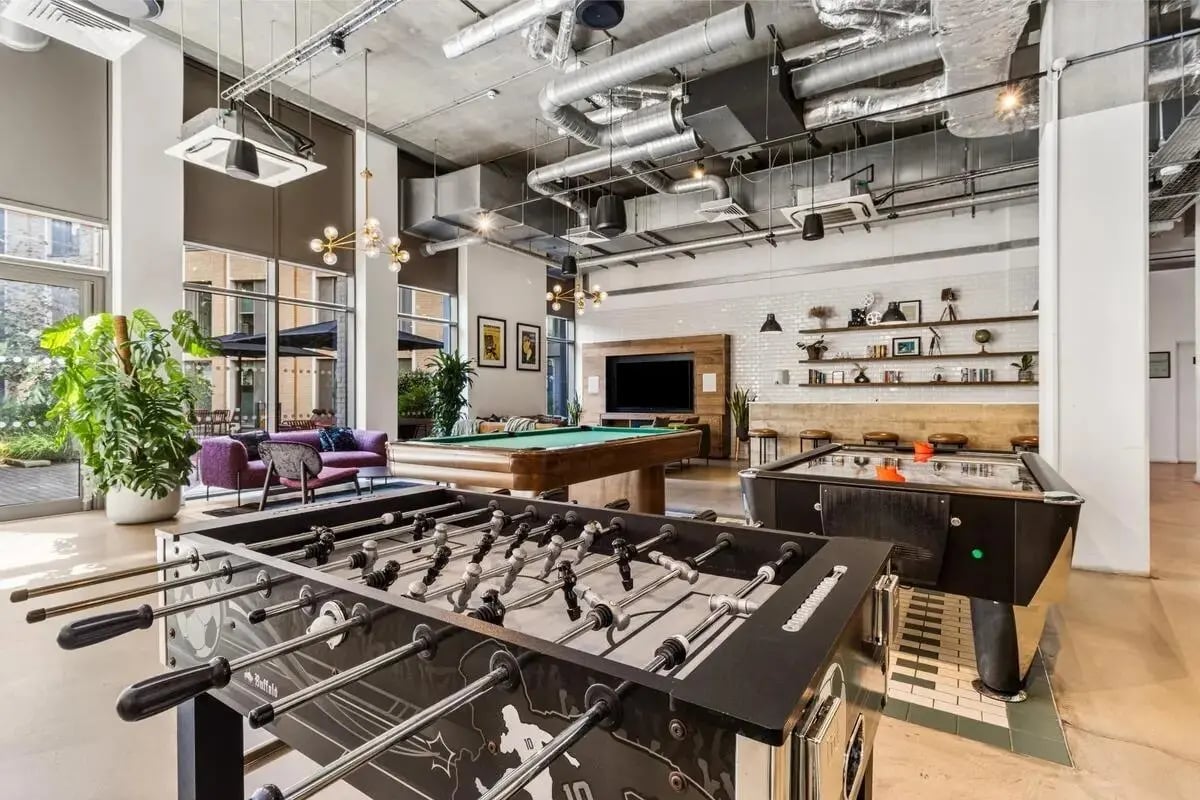 Foosball and pool tables with seating communal area at Chapter White City in London Student Accommodation