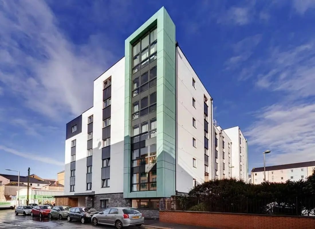 Modern student accommodation building with cars exterior at The Old Dairy in Plymouth Student Accommodation