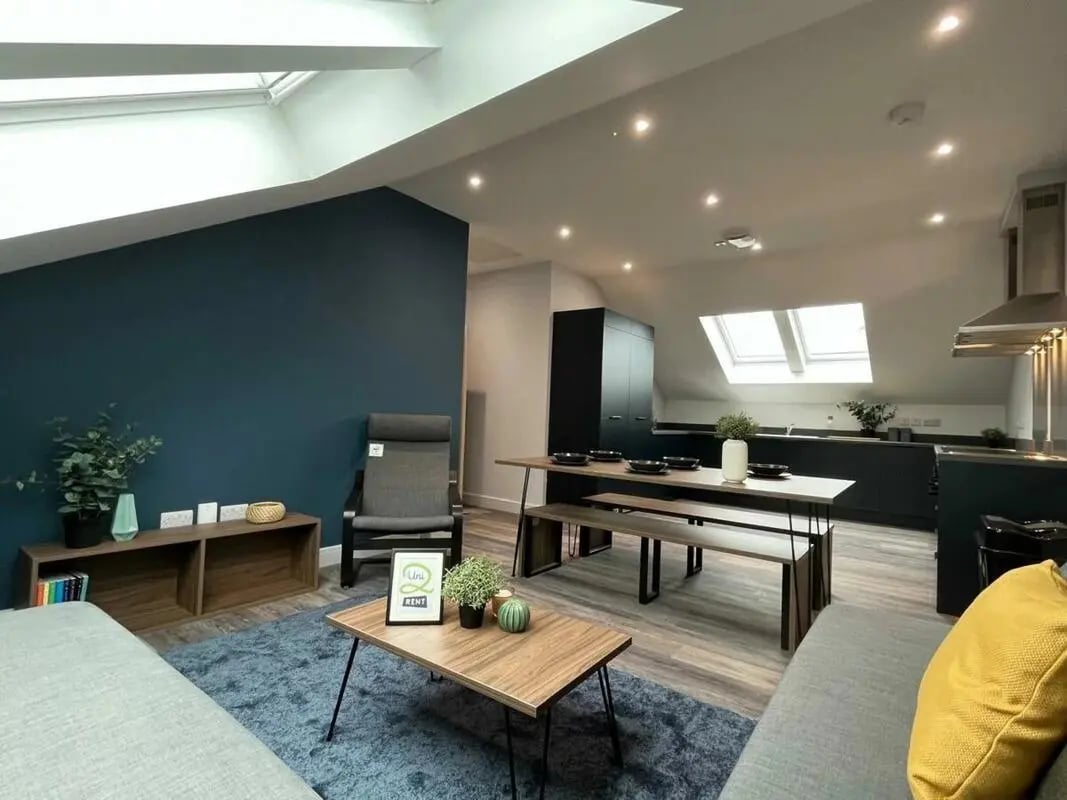 Living room with dining table and kitchen area at Commercial Point Nottingham in Nottingham Student Accommodation