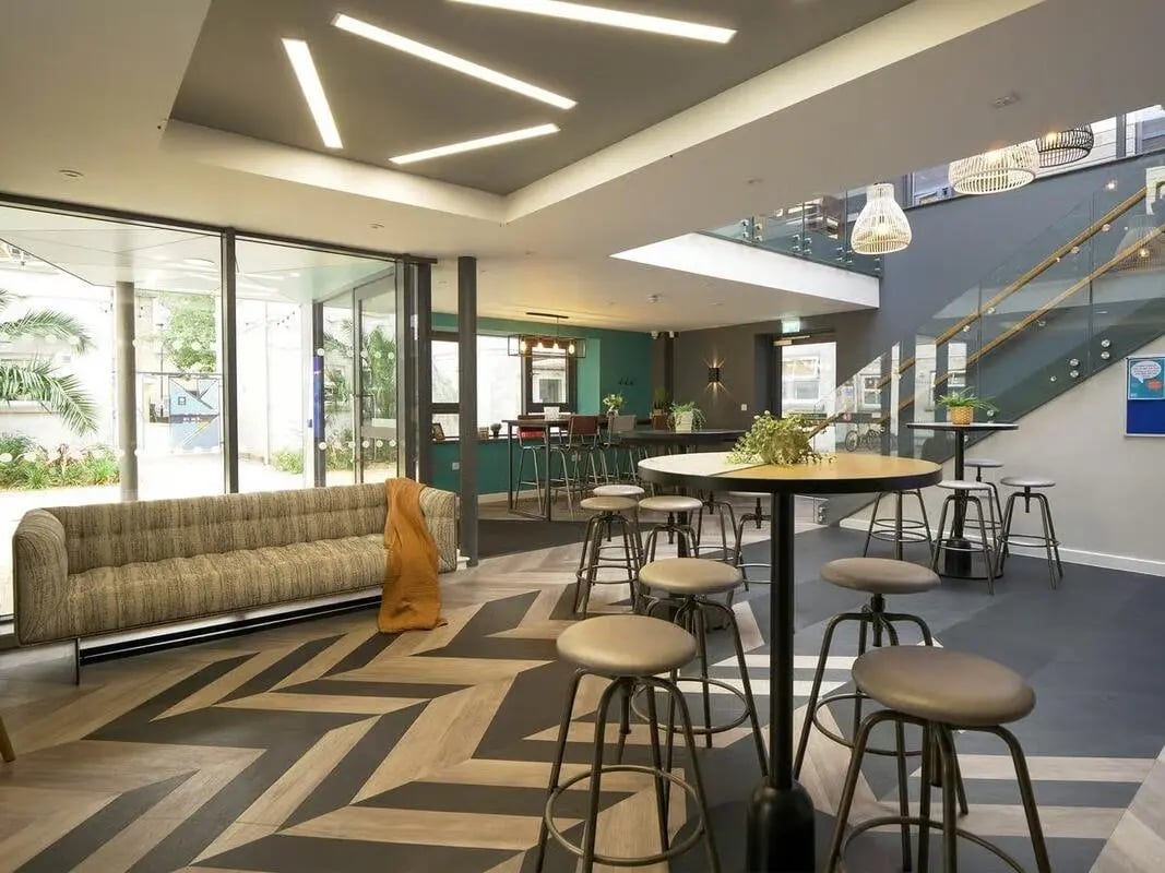Sofa bar stools circular tables communal area at Emily Davies in Southampton Student Accommodation