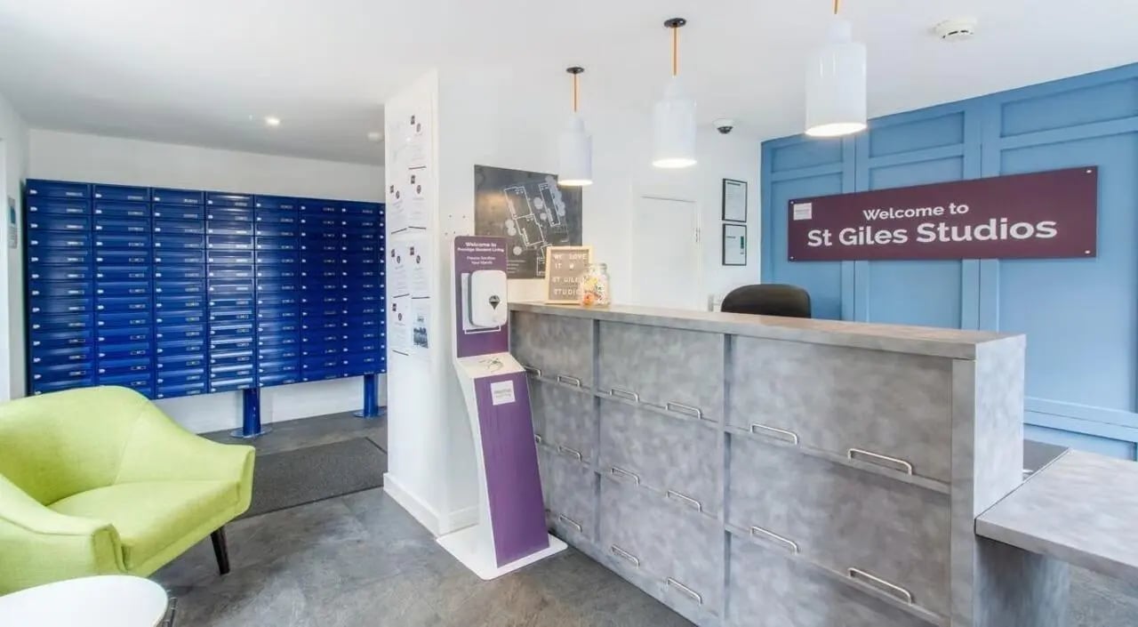 Mailboxes reception desk chair and signage exterior at St Giles Studios in Durham Student Accommodation