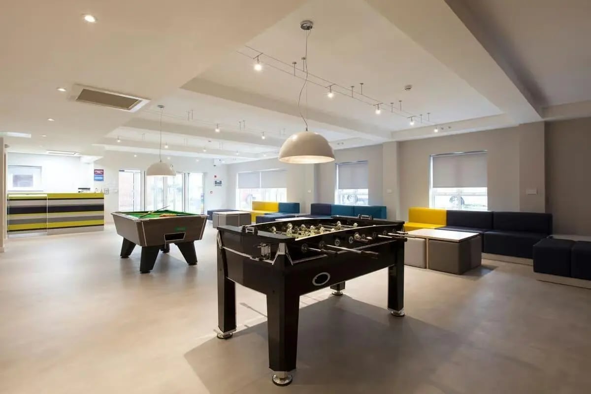 Pool table foosball table sofas reception area lounge at Selly Oak Court in Birmingham Student Accommodation