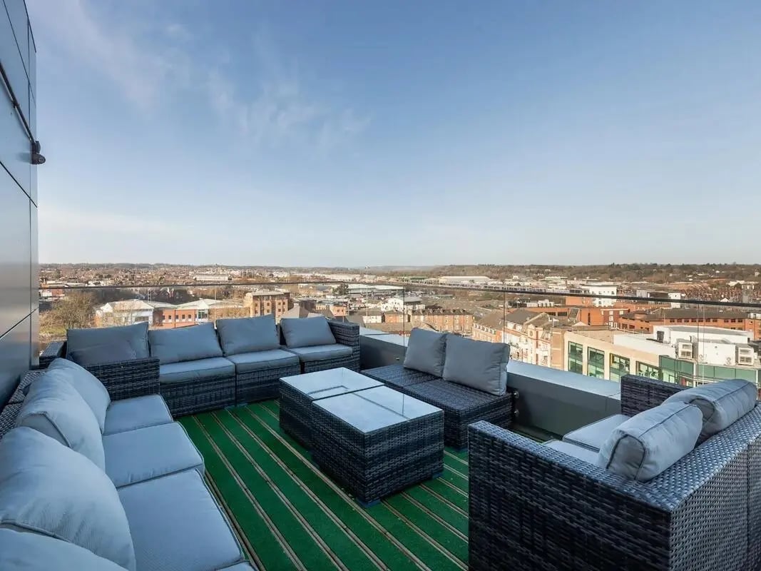 Wicker lounge seating glass coffee table balcony exterior at Central Studios Reading in Reading Student Accommodation