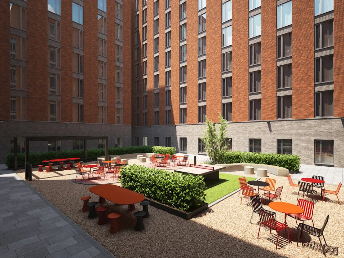 Outdoor courtyard with ping pong tables and seating exterior at Biscuit Factory in Belfast Student Accommodation