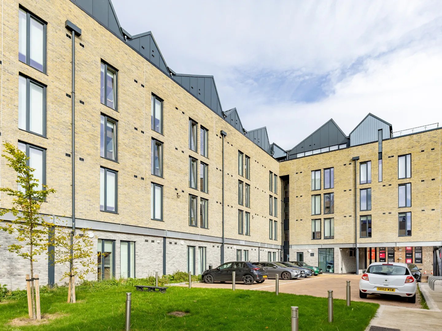 Modern building with cars in parking lot exterior at Stanley Studios - Dundee in Dundee Student Accommodation
