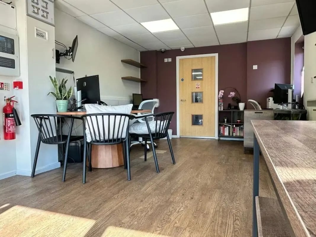 Desk chairs plant fire extinguisher door study area at The Railyard in Liverpool Student Accommodation