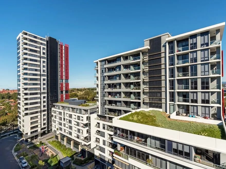 Modern apartment buildings with balconies green roof exterior at Belong Zetland in Sydney Student Accommodation