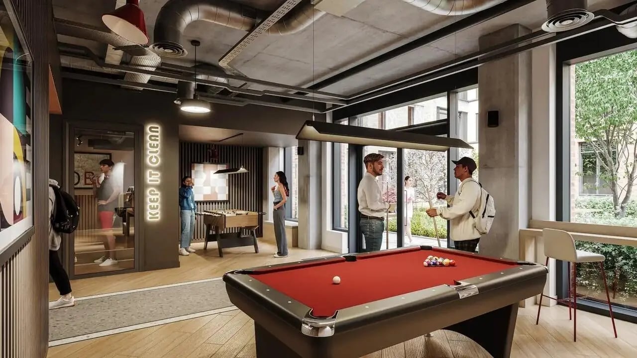 Pool table foosball table and seating area common room at Signal House in London Student Accommodation
