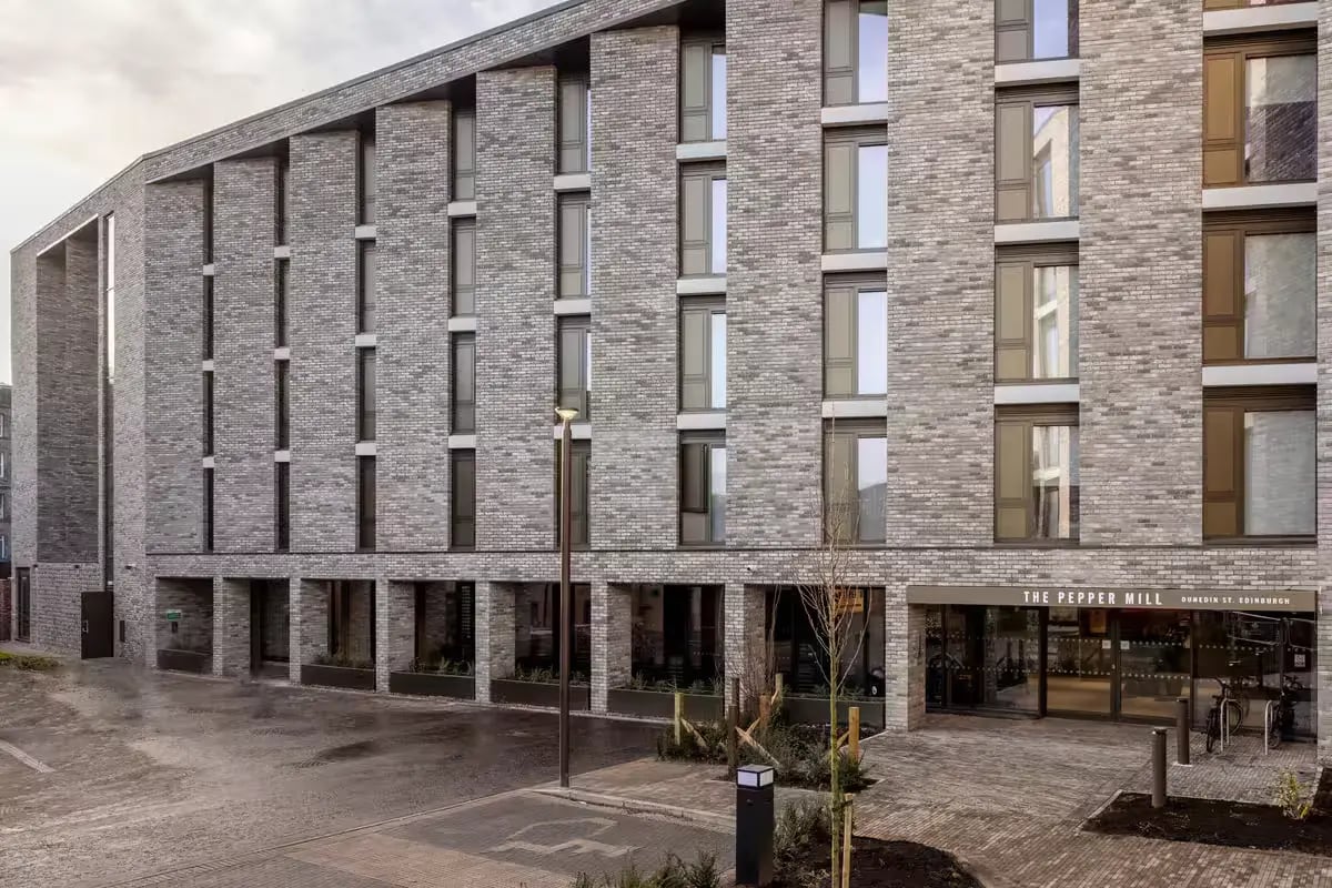 Modern brick building entrance with large windows exterior at The Pepper Mill in Edinburgh Student Accommodation