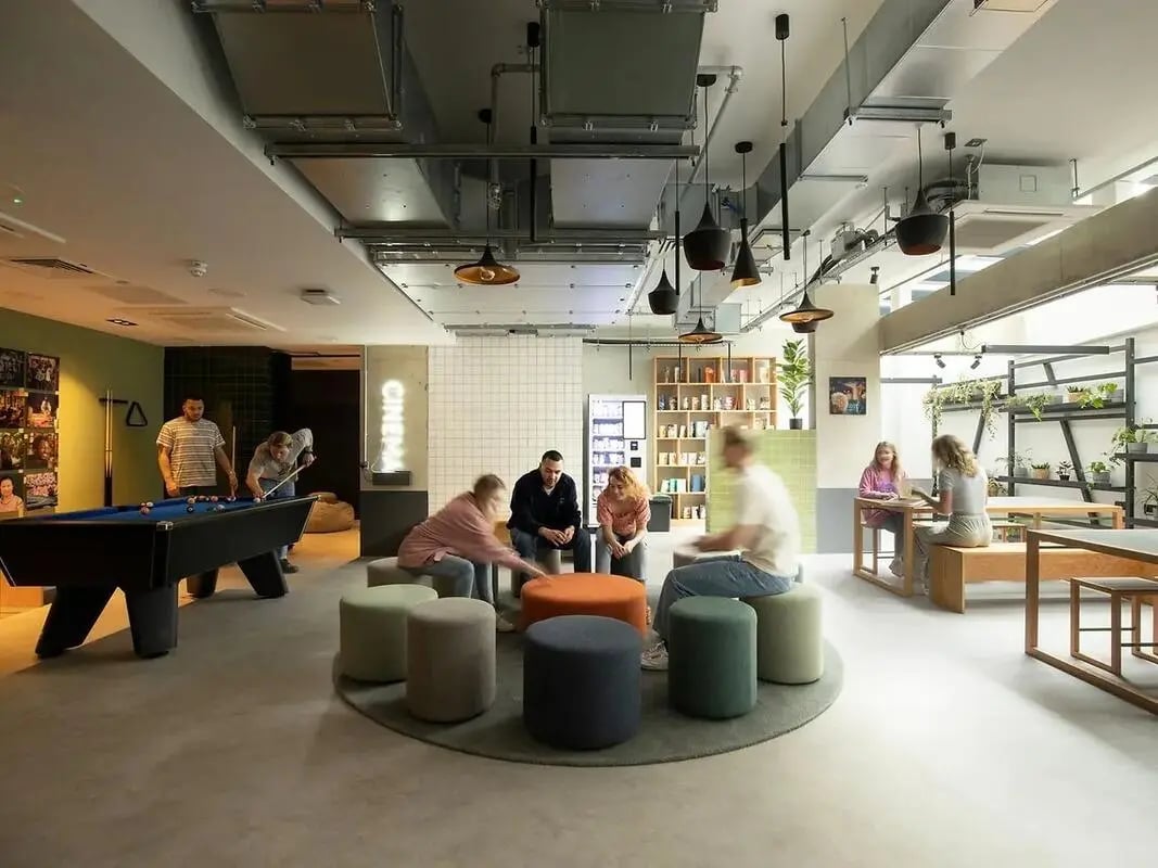 Pool table people sitting and chatting lounge area at Element Bermondsey in London Student Accommodation
