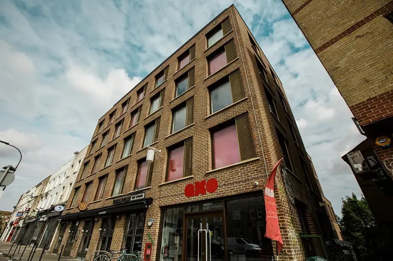 Brick student building with red OXO sign exterior at AXO New Cross in London Student Accommodation