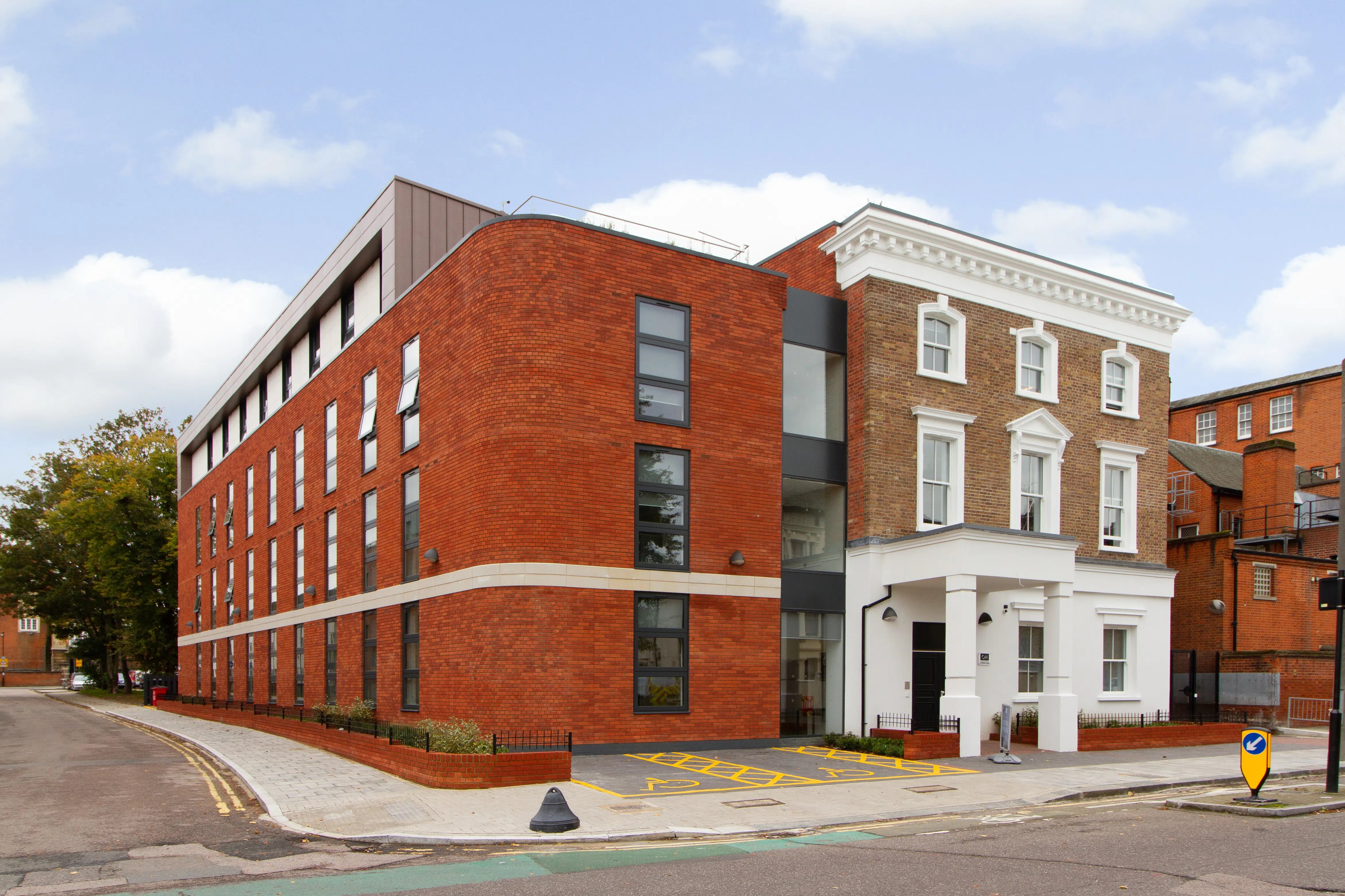Modern brick building with classic facade exterior at AXO Seven Sisters in London Student Accommodation