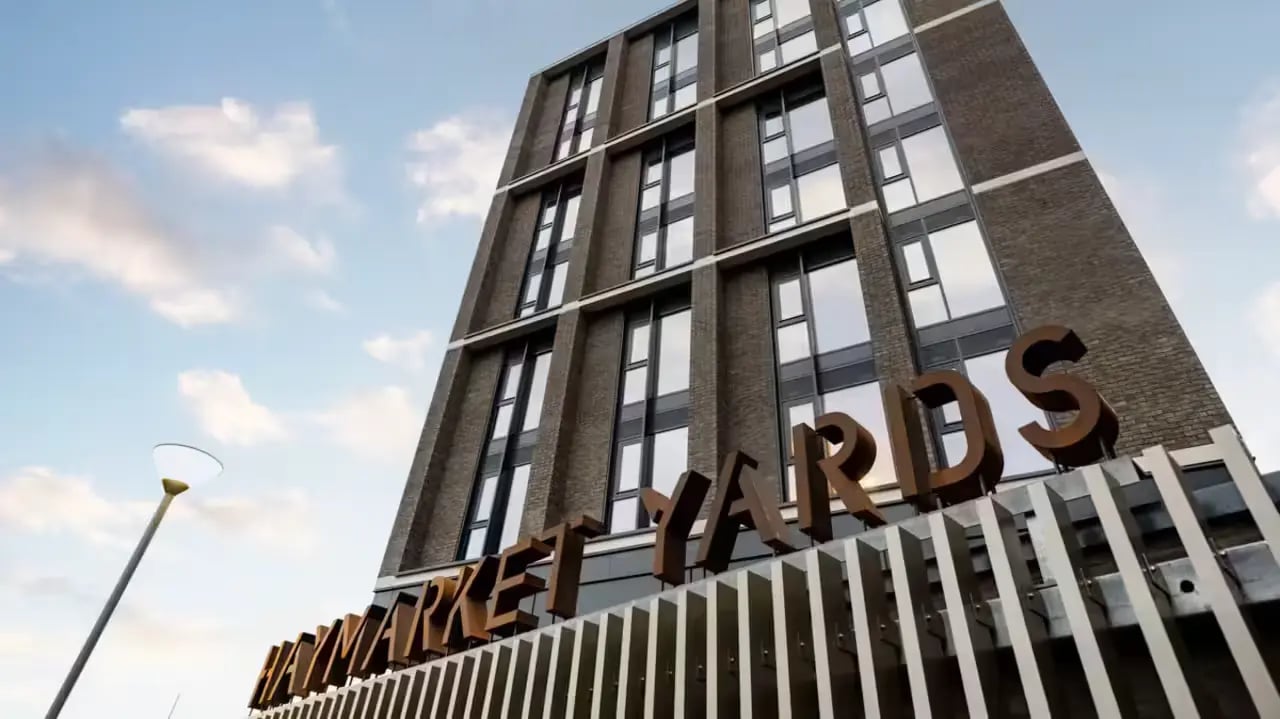 Tall brick building with sign exterior at Haymarket Yards in Edinburgh Student Accommodation