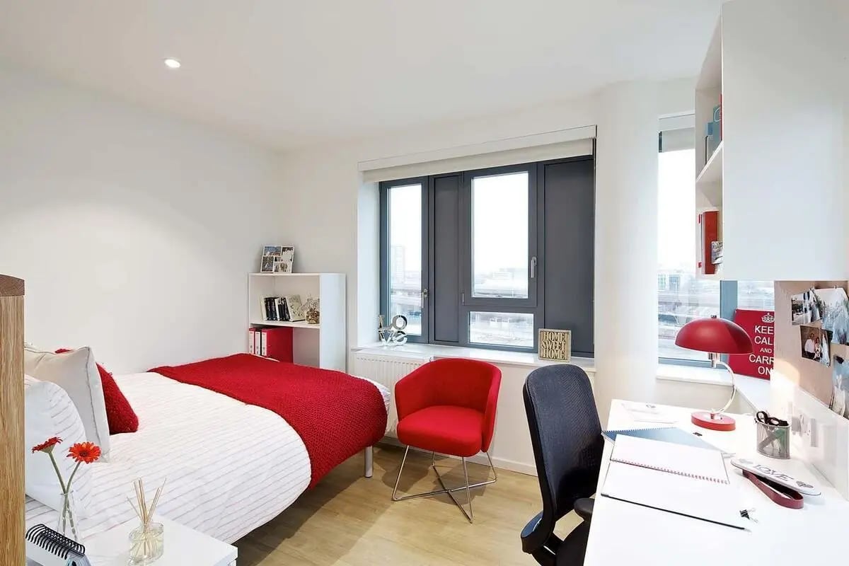 Bed desk red chair and bookshelf bedroom at Wood Lane Studios in London Student Accommodation