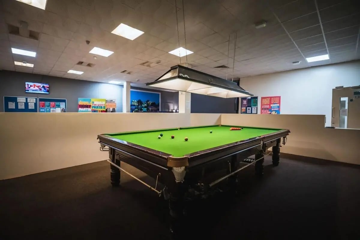 Pool table with balls and cues playing area at The Junxion Lincoln in Lincoln Student Accommodation