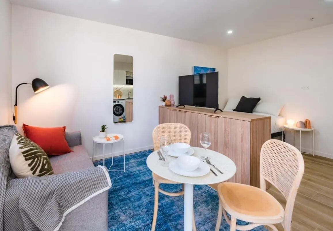 Sofa dining table bed television living area exterior at UKO Annandale in Sydney Student Accommodation