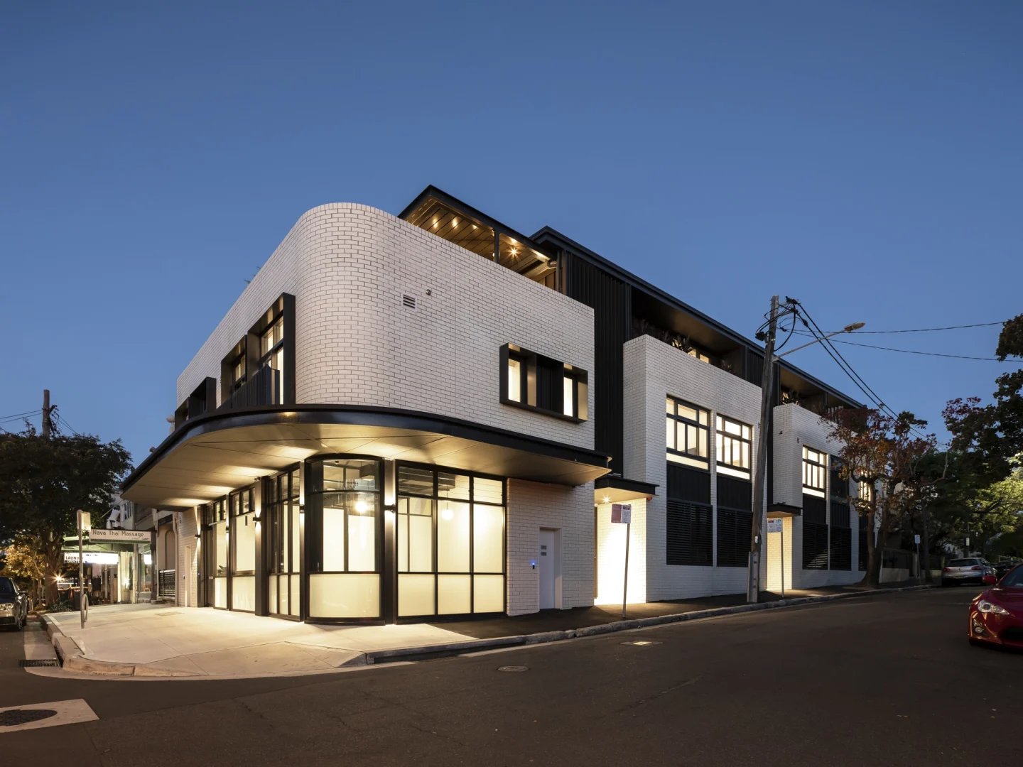 Modern white brick building with large windows exterior at UKO Glebe in Sydney Student Accommodation