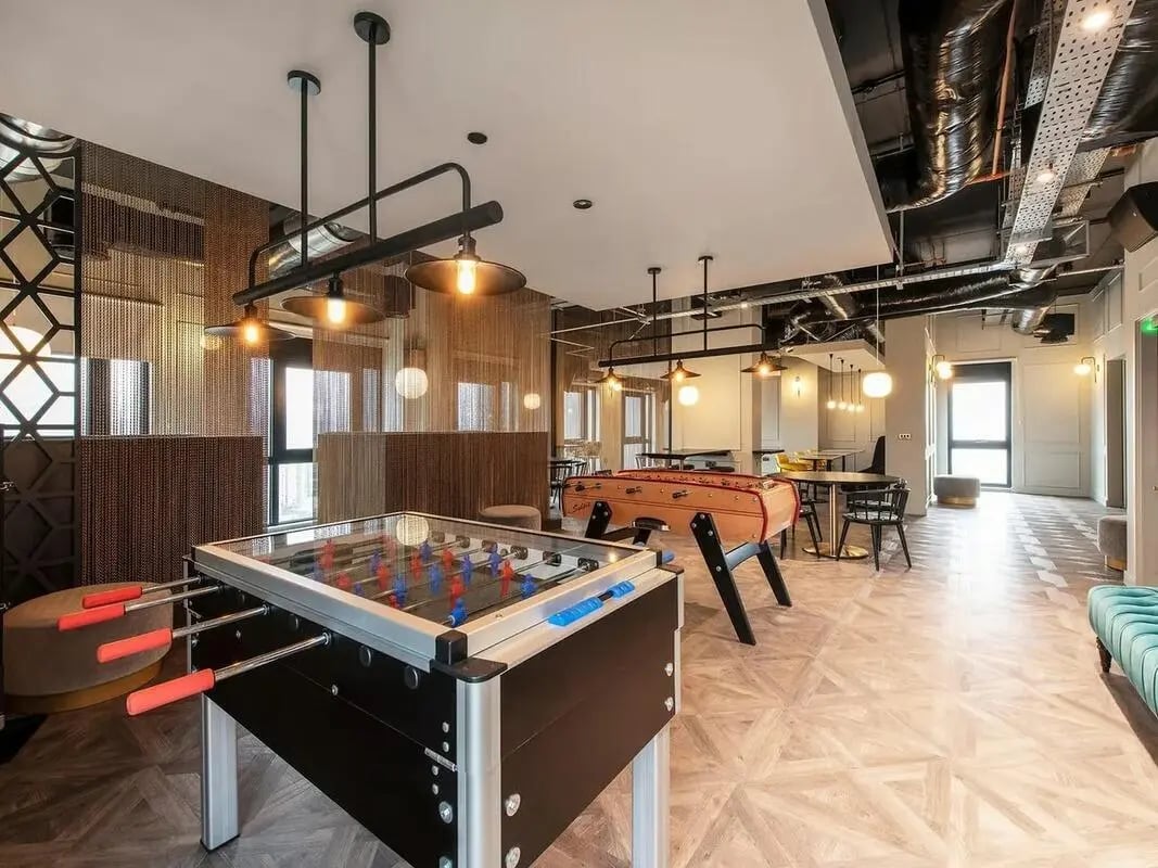 Foosball tables tables and chairs recreational room at Zenith in Cardiff Student Accommodation