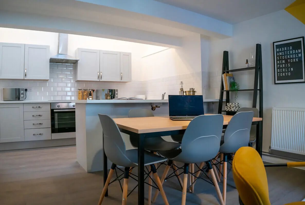 Kitchen dining table with laptop and chairs dining area at 6 Bedroom House at 64A, Monson Street in Lincoln Student Accommodation