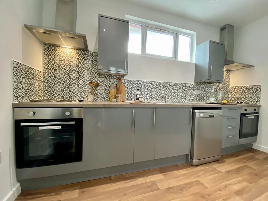 Modern grey kitchen with patterned tile backsplash kitchen at 2 Bedroom House at Flat 2, 36, CARLTON AVENUE in Manchester Student Accommodation