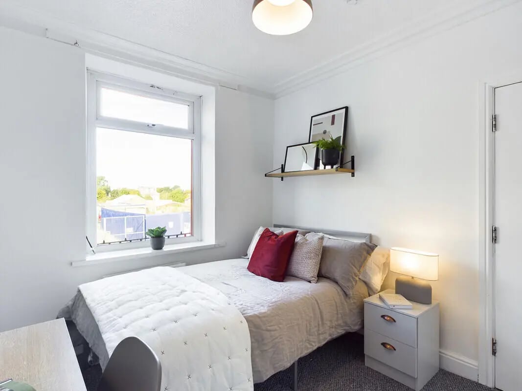 Bed with pillows and nightstand Bedroom at 6 Bedroom House at 75A, West Parade in Lincoln Student Accommodation