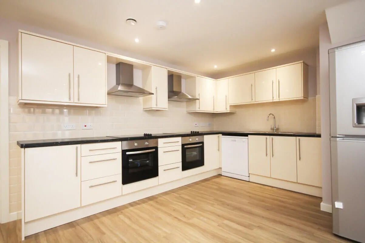 Cream cabinets ovens sink dishwasher refrigerator kitchen at 17 Bedroom House at 10, Ashton Studios, Well Meadow Drive in Sheffield Student Accommodation