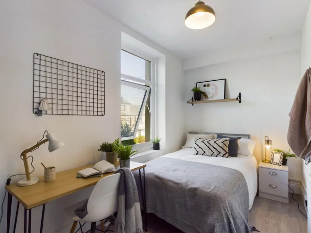 Desk bed pillows and shelf bedroom at 12 Bedroom House at 66, Upper Allen Street in Sheffield Student Accommodation