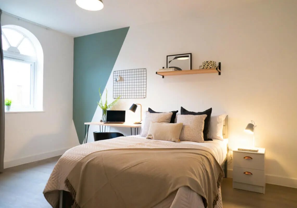 Bed desk laptop shelf pillows bedside table Bedroom at 8 Bedroom House at 67, Monks Road in Lincoln Student Accommodation