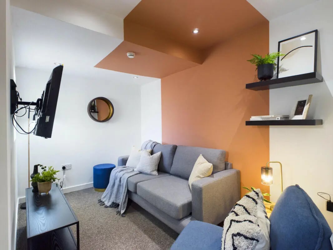 Gray sofa with pillows blanket and ottoman living room at 4 Bedroom House at 7, Westbourne Grove in Lincoln Student Accommodation