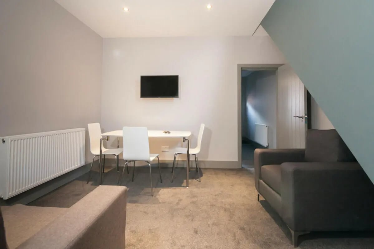 Dining table chairs sofa television living room at 3 Bedroom House at 1, Romney Street in Salford Student Accommodation