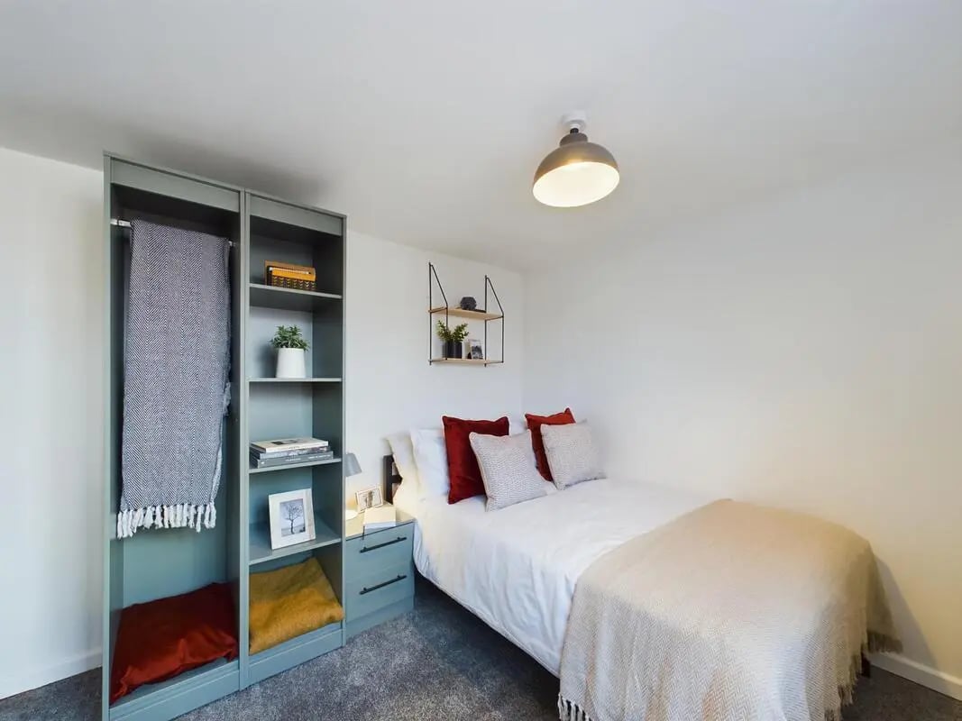 Bed with pillows and shelving unit bedroom at 7 Bedroom House at 6, KIPPAX STREET in Manchester Student Accommodation