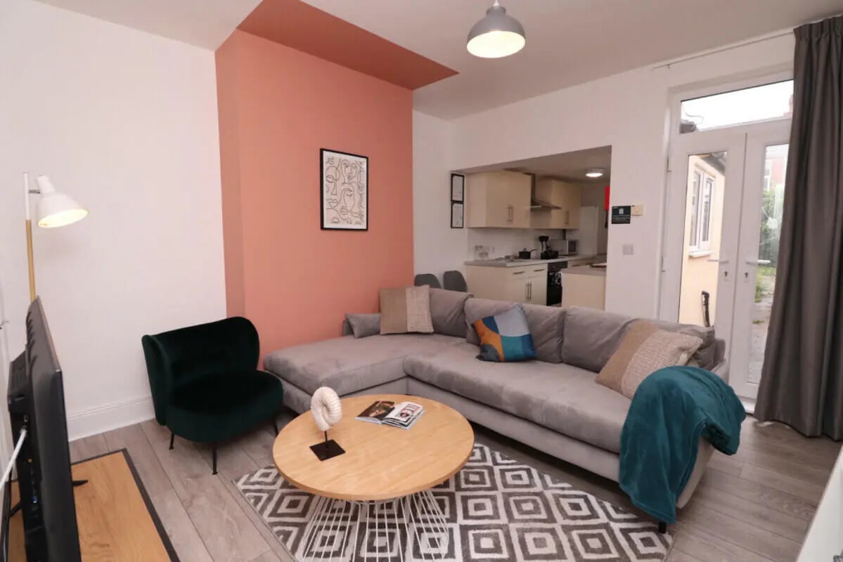 Sectional sofa coffee table artwork living room at 7 Bedroom House at 23, Crofton Street in Manchester Student Accommodation