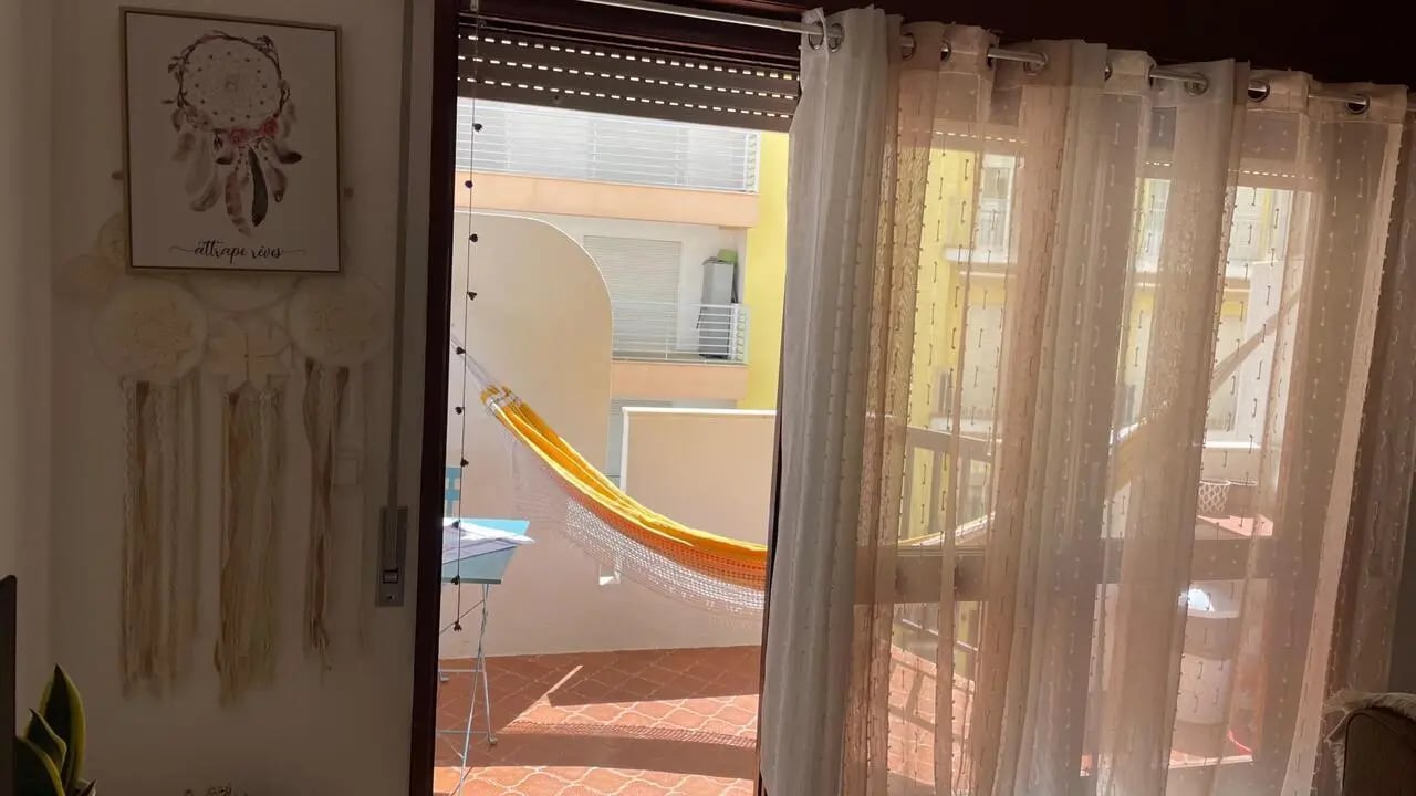 Hammock on balcony with wall art exterior at 1-bedroom flat in Armação de Pêra with balcony all electric no Gas in Silves Student Accommodation