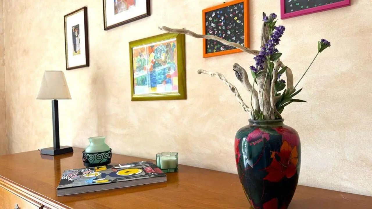 Framed art lamp candle and vase living room at Tasteful 1-bedroom apartment in Albenga in Albenga Student Accommodation