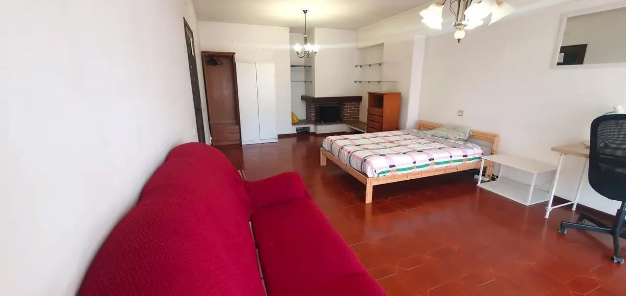 Bed sofa wardrobe fireplace and desk living room at Double Bedroom close to Minho University 3 in Guimaraes Student Accommodation