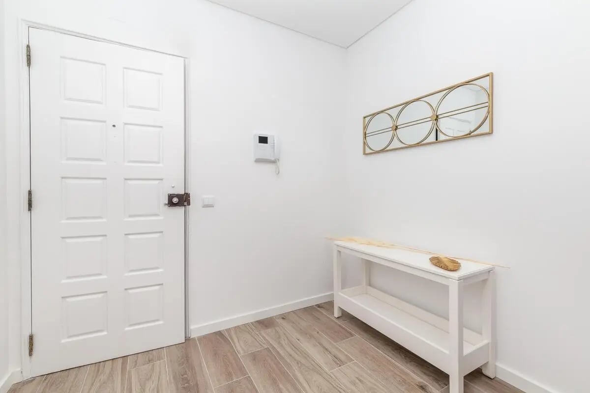 White door console table mirror entryway area at Neat 2-bedroom flat in Olhão in Faro Student Accommodation