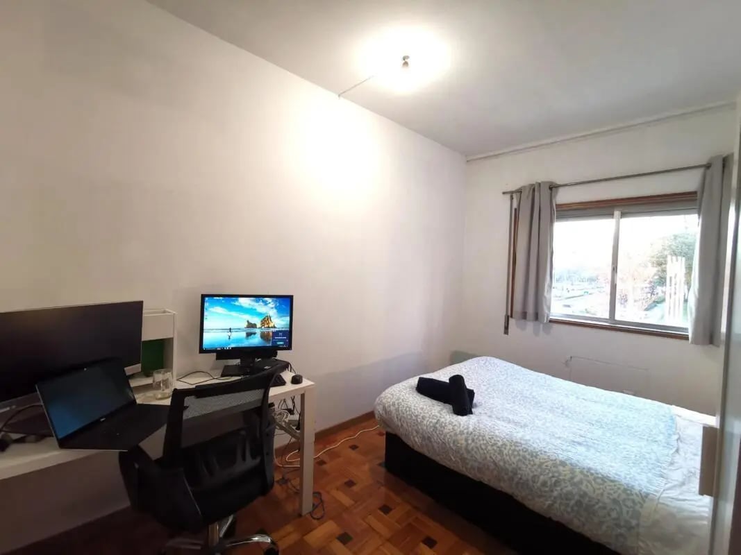 Desk with computers and bed bedroom at Double Bedroom available in the city center 5 in Guimaraes Student Accommodation
