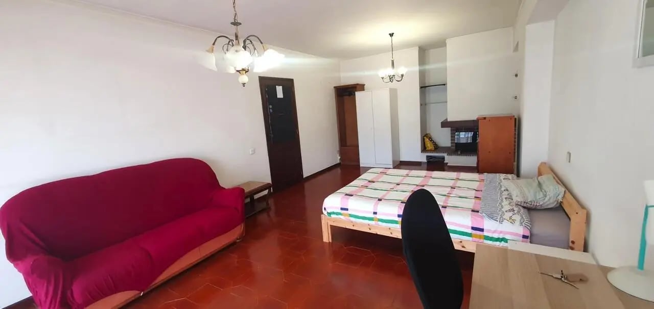 Red sofa bed wardrobe fireplace studio apartment at Double Bedroom close to Minho University 2 in Guimaraes Student Accommodation
