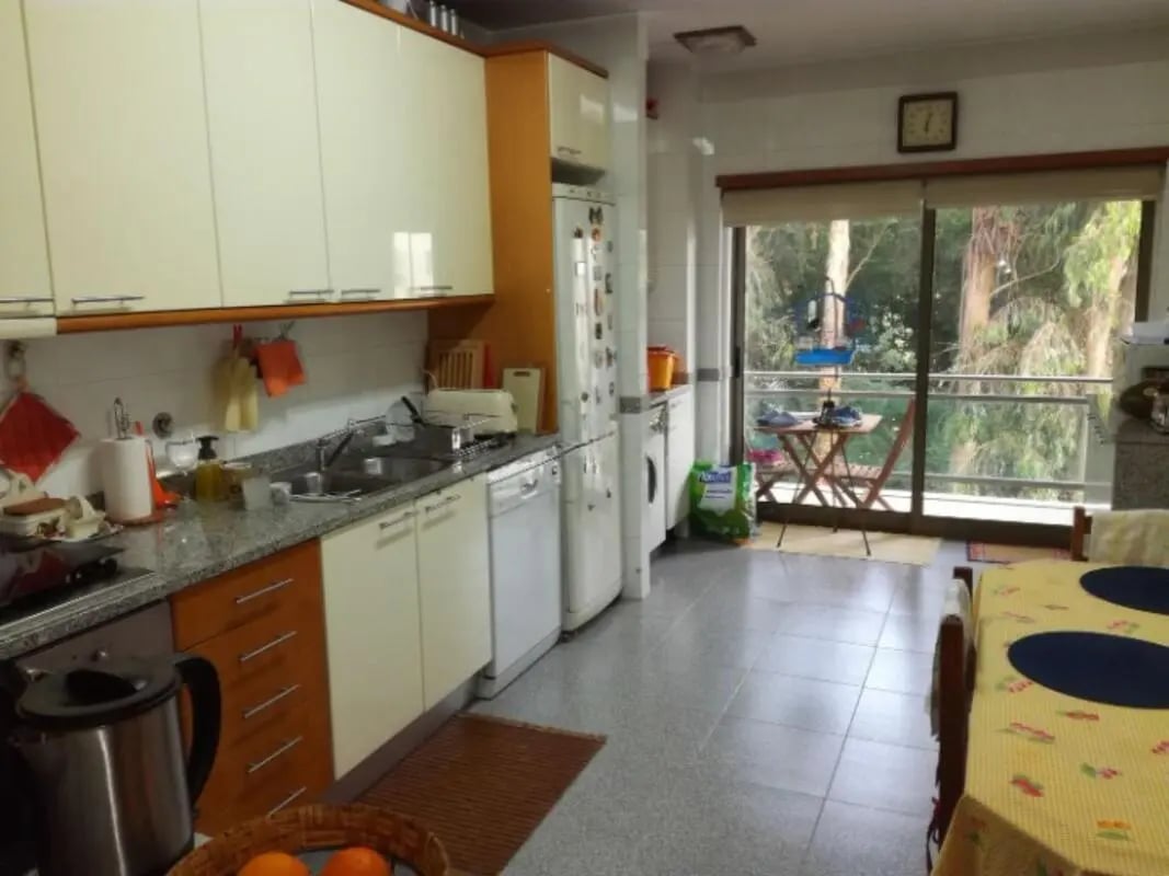 Cabinets sink dishwasher appliances and balcony kitchen at Cosy Single Bedroom with a balcony in a 3-bedroom apartment close to Universidade do Minho in Guimaraes Student Accommodation