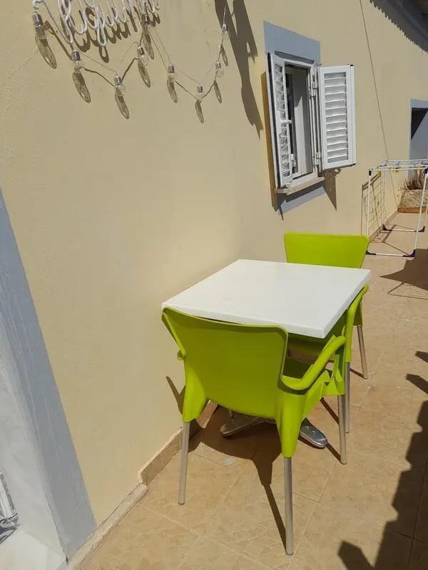 Table and chairs on patio exterior at Comfy studio with an outdoor area in Albufeira Student Accommodation